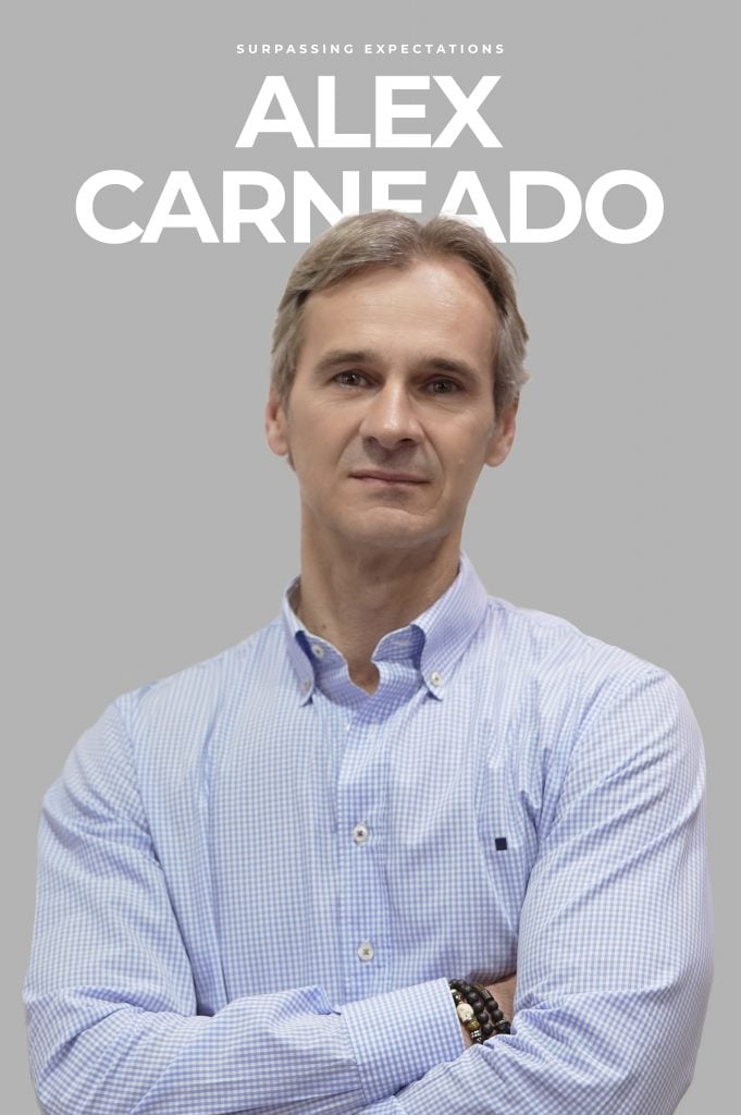 man with blue shirt and crossed arms