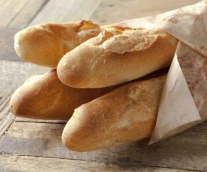 close-up of french baguettes wrapped in paper
