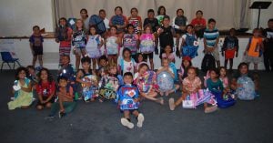a group of children with backpacks