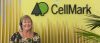 smiling receptionist woman in front of cellmark logo wall