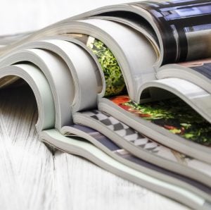 stack of magazines on a white-painted wooden table